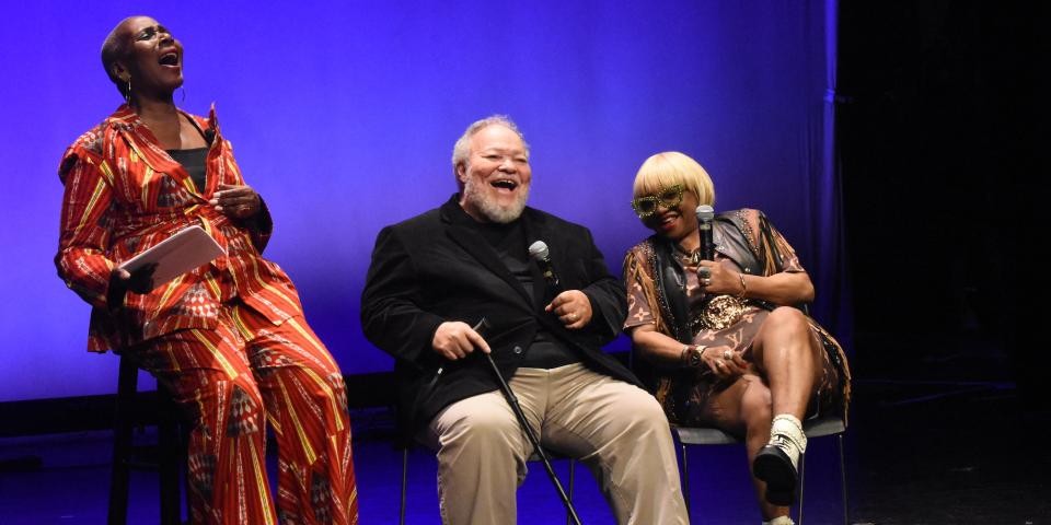 Performers laugh onstage at the Schomburg Center. 