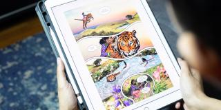 Teenager reading graphic novel on iPad