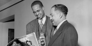 Langston Hughes and Morehouse student and photographer Griffith J. Davis, class of 1947, reading Ebony Magazine at Hughes' faculty apartment, 1947. Griffith J. Davis Photographs and Archives.