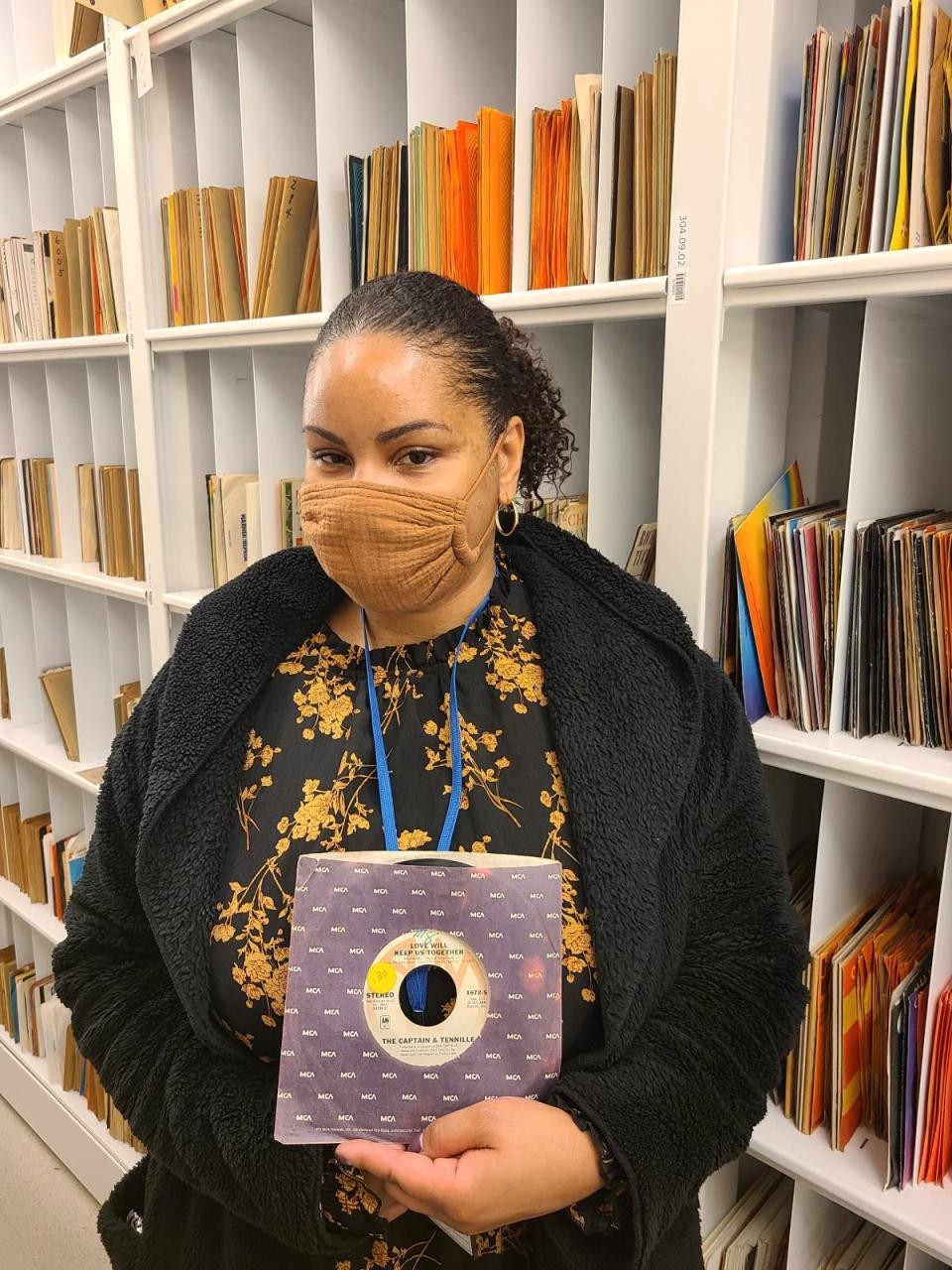 librarian holding up a 45 single of 