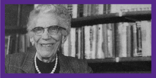 Purple border surrounding historic black-and-white photo portrait of NYPL's Mabel Williams smiling and wearing pearls and blazer while standing in front of a bookshelf