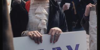 Transgender activist, Sylvia Rivera, holding a sign reading "Gay Power". She is wearing fabulous sunglasses.