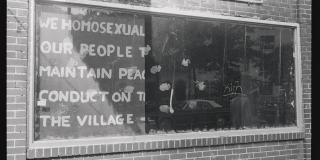 A sign in the window of Stonewall Inn saying "WE HOMOSEXUAL/OUR PEOPLE/MAINTAIN PEACE/CONDUCT ON THE/VILLAGE