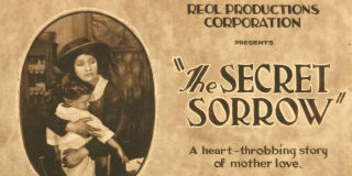 Closeup of a poster featuring a Black woman clutching a child and text that reads: Reol Productions Corporation Presents The Secret Sorrow A heart-throbbing story of mother love.