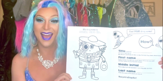 Still from a Drag Story Hour video featuring a performer in a blue and pink wig holding a book up in front of the camera. 
